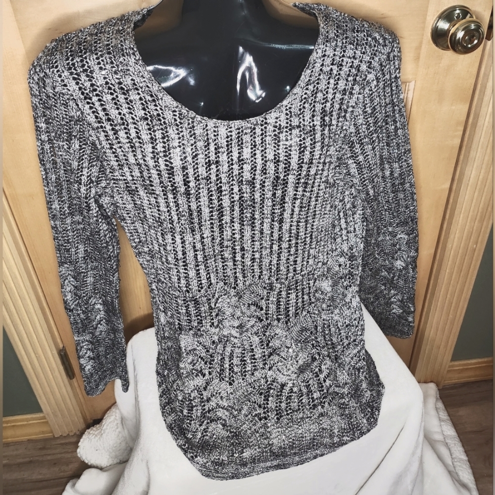 Open weave, sequenced, long sleeve sweater that is like new.